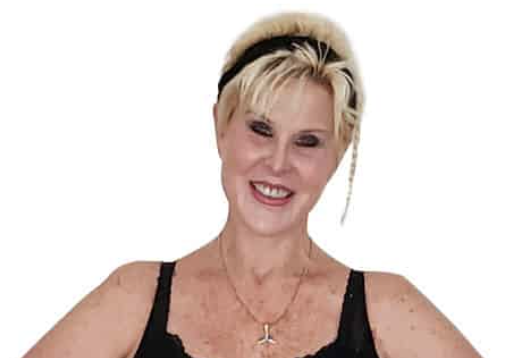 Confident Woman Smiling Smiling woman with short blonde hair wearing a black top and headband